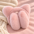 Pink cat-ear earmuffs on blush pink beside a cream scarf